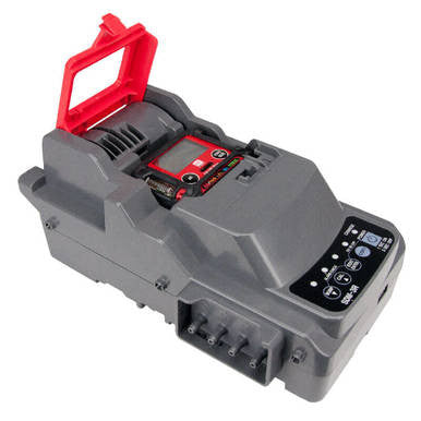 A gray RKI SDM-3R Stand Alone Calibration Station 81-SDM3R101 power tool battery charger, featuring a red handle and digital display, has numerous buttons and indicators on the front panel.
