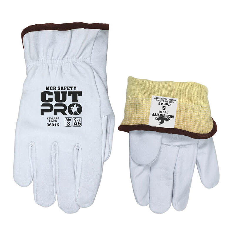 Two MCR Safety Premium Grain Goatskin Driver Gloves 3601K with brown trim: one palm-up showing safety labels, the other inside out revealing a yellow Kevlar cut-resistant liner and an attached safety label.