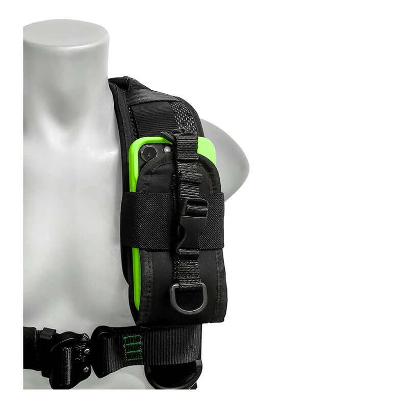 A close-up of a mannequin wearing the Frontline Elite Vest Harness Aluminum HW & Trauma Straps by Frontline Fall Protection, with a pouch on the shoulder strap partially holding a green smartphone.