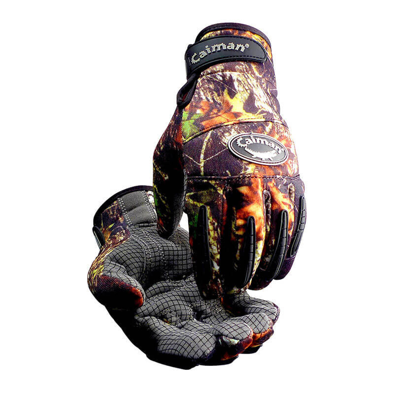 The PIP Caiman Synthetic Leather Silicone Grip Gloves from PIP - Protective Industrial Products feature a camouflage design with branded logos on the wrist and back of the hand. One glove is open to reveal its silicone grip palm, while the other is slightly closed, emphasizing its intricate design and meticulous attention to detail.