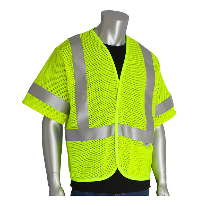 A mannequin displays the PIP ANSI Type R Class 3 AR/FR Mesh Vest 305-3100 from Protective Industrial Products, a high-visibility garment that features a bright yellow, short-sleeved safety vest with reflective silver stripes over a black shirt. The mesh material provides comfort while adhering to ANSI Type R Class 3 standards for improved visibility.
