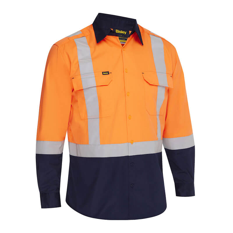 The PIP Bisley Vented Work Shirt w/Navy Bottom 312M6367H, in Hi-Viz Orange, features reflective silver tape, long sleeves, two front pockets, and moisture-wicking fabric for comfort and safety in industrial settings.
