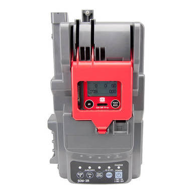 The image displays a rectangular electronic device resembling an RKI SDM-3R Stand Alone Calibration Station, featuring a digital display and buttons. The device is gray and red, marked with technical specifications similar to those of the GX-3R portable gas monitor.