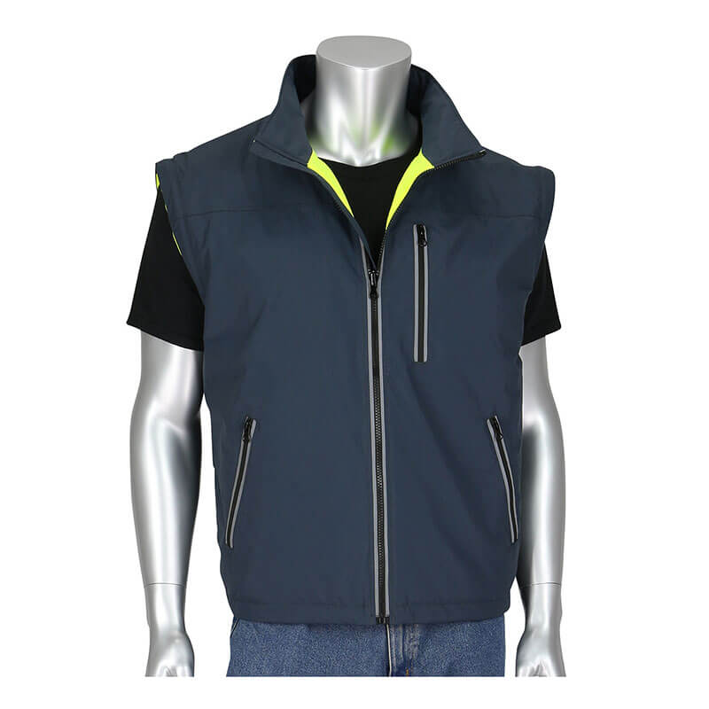 A mannequin is dressed in the PIP Black Label 4-in-1 Reversible Windbreaker by Protective Industrial Products, featuring a sleeveless design in dark blue with a high collar, front zipper, and two side zipper pockets. The windbreaker is layered over a black t-shirt, revealing a hint of yellow fabric on the inside. It stands poised against a plain white backdrop.
