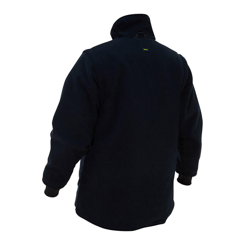 A woman, seen from behind, wears the PIP Bisley Women's 5-in-1 Jacket w/Navy Bottom from Protective Industrial Products. The jacket is plain yet functional, emphasizing warmth and simplicity while ensuring comfort on cooler days with its dark long sleeves and high collar.