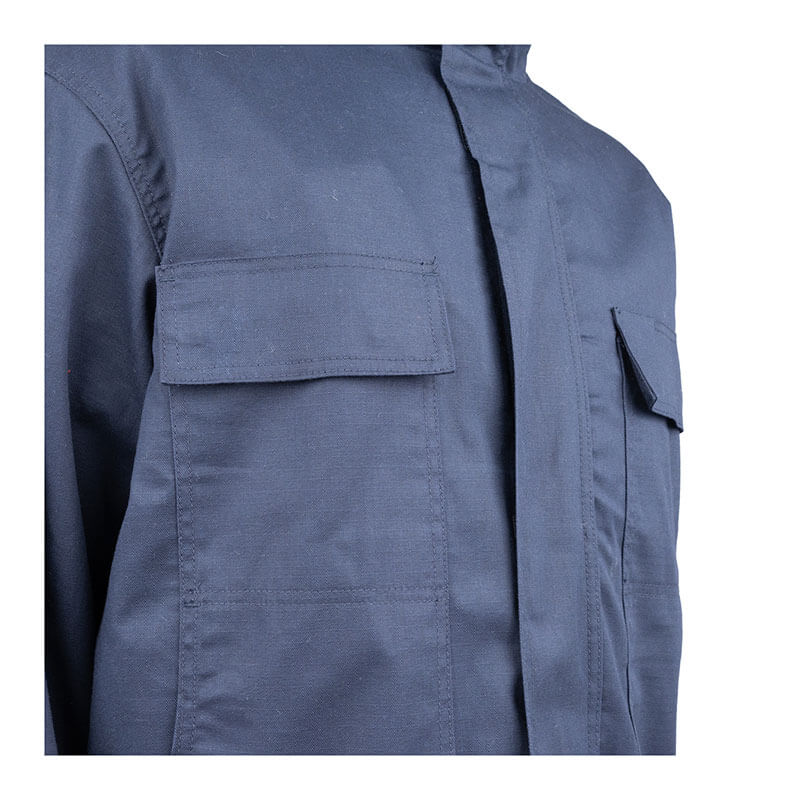 Close-up of a person wearing the PIP 4-in-1 AR/FR Ripstop Jacket With Zip-Out Liner 385-FRFC in dark blue. This sturdy jacket from PIP has two chest pockets with flaps, a hidden front zipper closure, and is flame-resistant, making it perfect for outdoor or work environments.