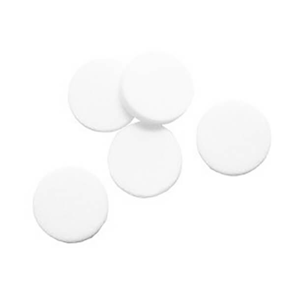 Five round, white tablets are scattered on a plain white background, resembling components from a BW Technologies by Honeywell GA-PFMAX-100 Pump Filter or intricate gas monitor parts.