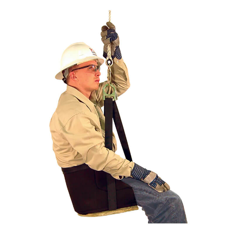 A worker wearing PPE sits in a French Creek Production Deluxe Work Seat 4153, suspended by rope and holding onto it above with one hand, demonstrating proper fall protection.
