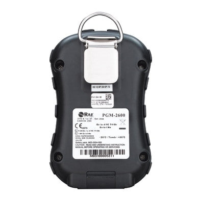 Back view of the PK Safety Supply MicroRAE 4-Gas Diffusion Monitor M031-1111-200, featuring a dark casing and a silver clip on top. Several labels with technical details, serial numbers, and a barcode are present. The device offers real-time readings for precise monitoring and enhanced wireless connectivity capabilities.