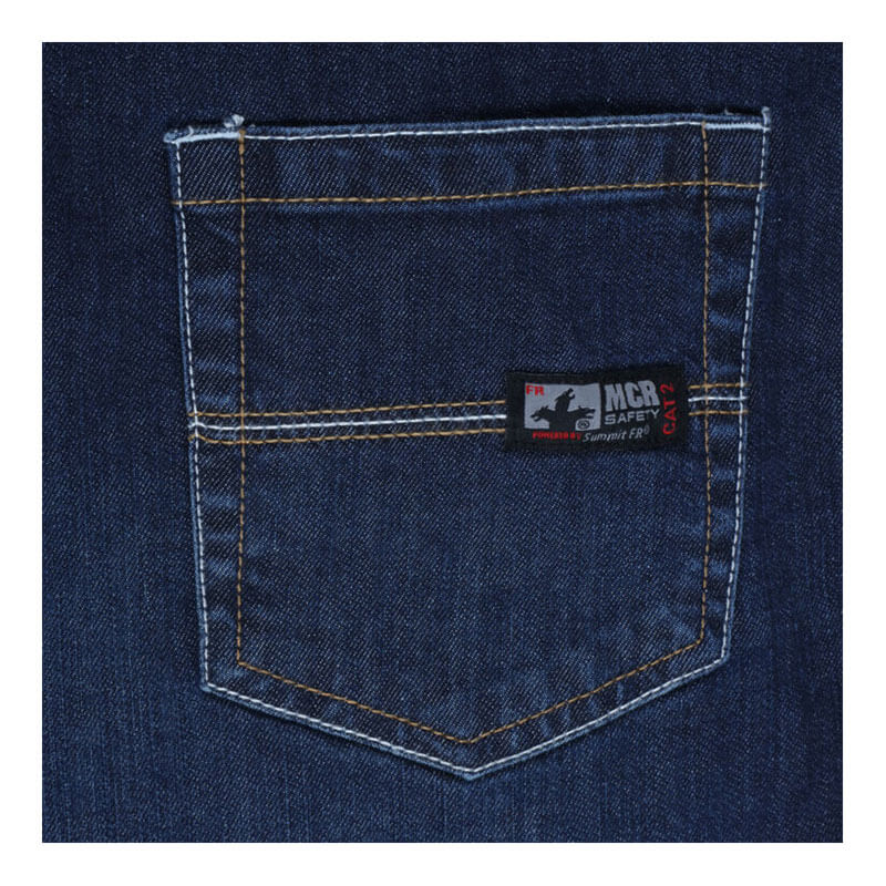 Close-up of MCR Safety FR Gear 10.5 oz Vintage Denim Jeans P2D featuring blue flame-resistant denim, yellow stitching, and a small "MCR Safety CAT 2" label on the pocket's upper right, showcasing their CAT2 protection.