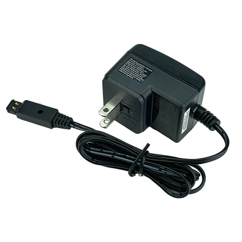 The RKI Instruments GX-3R/GX-3R Pro/SDM-3R AC Adaptor 49-0133 is shown with a coiled cable ending in a rectangular connector and two-prong plug, designed for GX-3R series gas monitors.