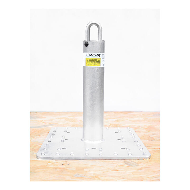 The Frontline Multifunction Commercial Roof Anchor by Frontline Fall Protection, with a square base and vertical cylindrical post featuring a top loop and ID label, is mounted on wood. Made from ASTM-rated steel for durability.