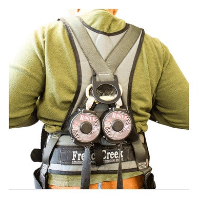 A person wearing a green shirt with a gray support harness that incorporates the French Creek Rogue Dual Leg Rebar Hook SRL M2RG-4Z, which includes dual leg rebar hooks and features two round, black and red pulleys labeled "Rogue" on the back. The strap bears the name "French Creek," emphasizing 100% tie-off safety while showcasing the fall arrest D-ring design.