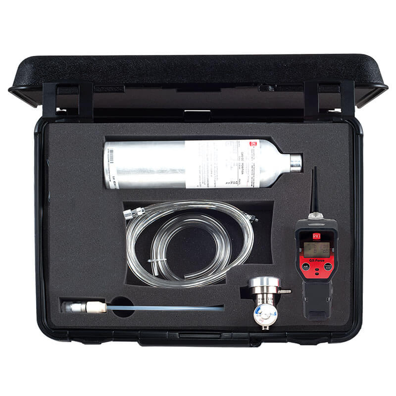 The RKI GX-Force Instrument Bundle by RKI Instruments comes in a black case and includes a CO detector kit, calibration gas with a silver gas cylinder, a black and red GX-Force Monitor, coiled hose, and various connectors. All components are neatly arranged in custom foam padding.
