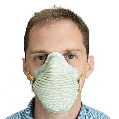 A person wearing a Moldex N95 Disposable Waved Respirator 4600 with yellow straps, covering their nose and mouth, is shown against a plain white background.