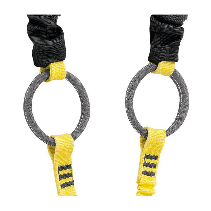 A close-up of two gray metal rings connected by yellow straps with black stitching highlights the Petzl Absorbica-Y Tie Back MGO Double Lanyard L015BB00 from Petzl, set against a plain white background. The straps seem to be part of a suspension or climbing harness featuring an integrated energy absorber design.