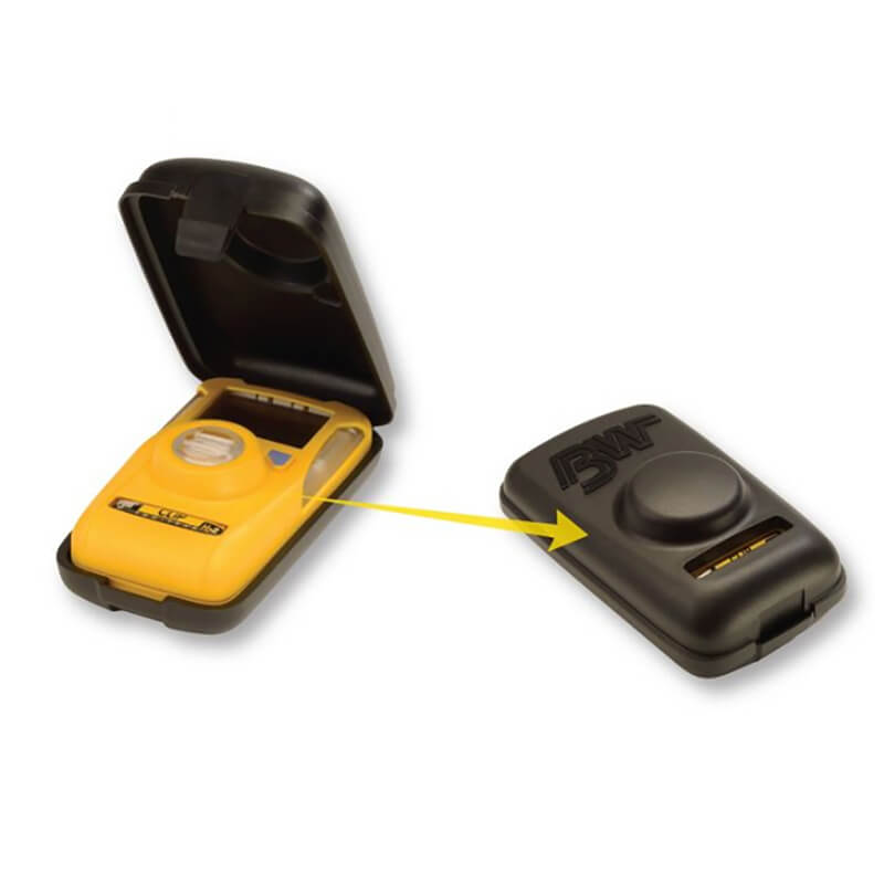 An open yellow handheld device, which seems to be a BW Clip gas monitor, features a digital display and buttons showing its internal components. Beside it sits a closed black PK Safety Supply BW Clip Hibernation Case (Model: CLIPHB-CASE), marked by a central raised section, highlighted by an arrow.
