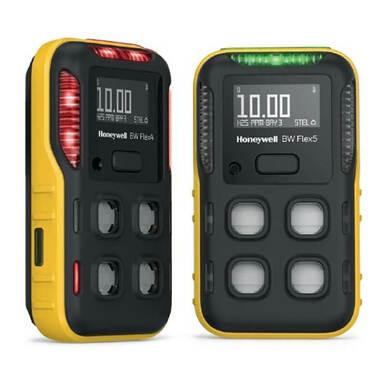 Two BW Technologies by Honeywell BW Flex4 4-Gas Detectors are displayed, featuring yellow edges, black fronts, and screens with numerical readings. They're designed for gas hazard detection and have multiple sensor ports and LED indicators above the screens.