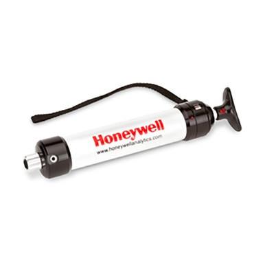 The LP-1200 Piston Hand Pump by BW Honeywell is a stylish handheld gas detector pump, showcasing a white cylinder with black end caps and a handy strap. It’s intended for use with gas detection tubes, and the prominent Honeywell logo is boldly printed in red on the side.