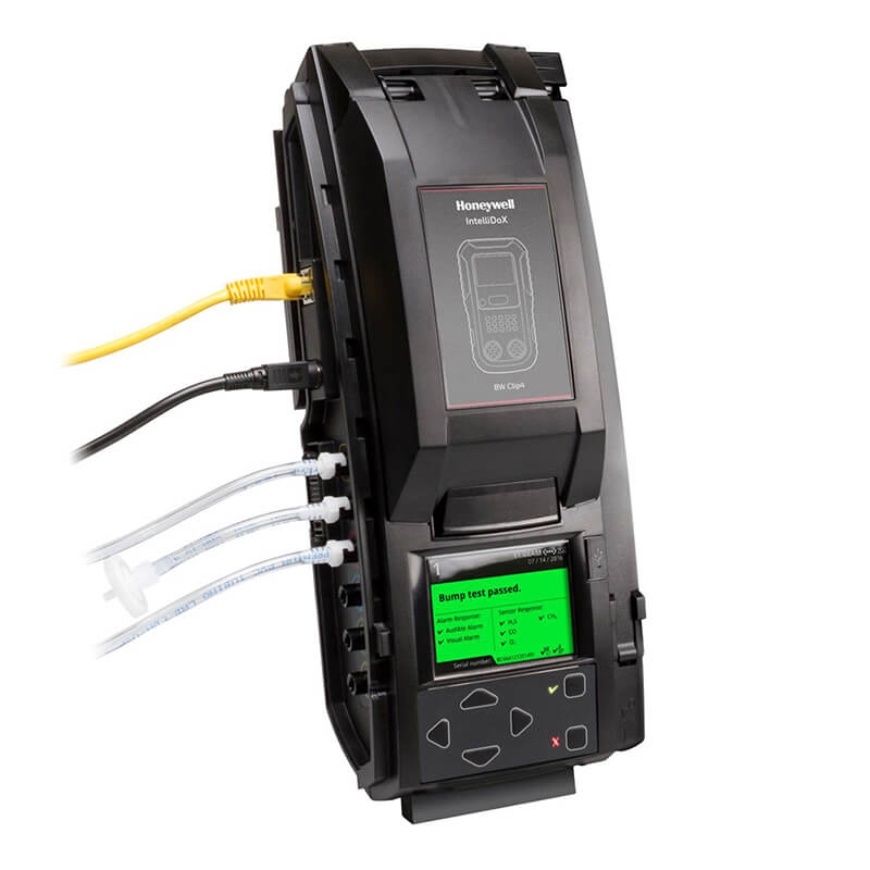 A BW IntelliDoX Docking Station for BW Clip4 DX-BWC4 in black, featuring a display screen and multiple ports. The station is connected with cables, including a yellow network cable and three white cables. There are controls and an additional screen at the bottom for efficient automated instrument management.