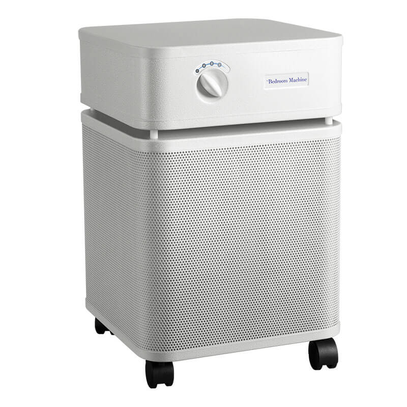 The Austin Air Systems Bedroom Machine B402 is a white, box-shaped air purifier with a front control knob, mesh sides, four wheels for mobility, and a medical grade HEPA filter for advanced purification.
