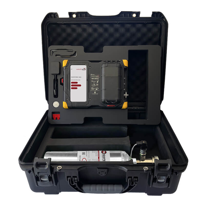 A black hard case opens to reveal the WatchGas SST Dock Bundle, featuring a calibration gas canister, control device, and organized equipment in compartments with black foam padding.