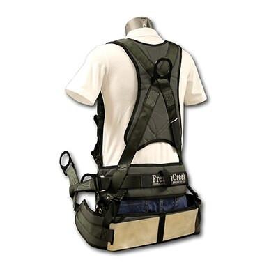 A mannequin is displayed wearing a white shirt and a black French Creek Stratos Series Harness by French Creek Production, designed ergonomically for tree climbing. This safety harness features multiple straps, back support with Strato-lite padding, a brand label on the back, and various attachment loops.