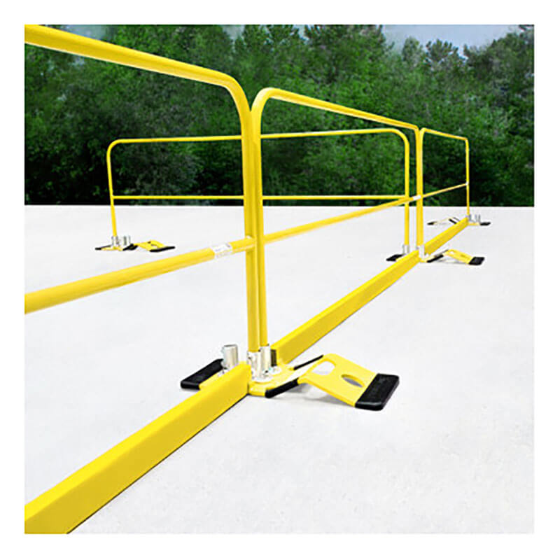Frontline Fall Protection’s yellow Frontline 10' Guardrail Toe Board GUTO is installed outdoors on a flat white surface, delivering OSHA-compliant safety and high visibility with trees and greenery visible in the background.
