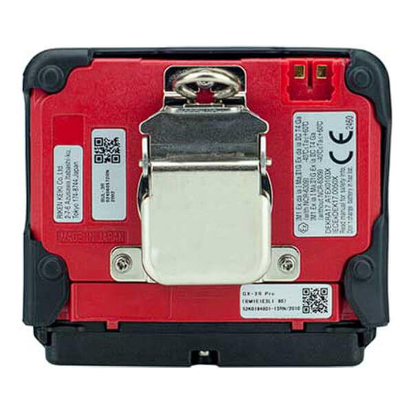 The image shows the back of the RKI Instruments GX-3R Pro 5 Gas Confined Space Monitor with Wireless Communication, featuring a red panel, central metal clip, QR codes, technical labels, and two gold contacts at the upper right.