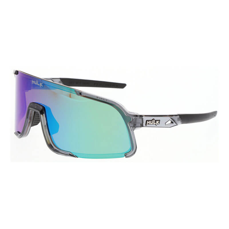 The MCR Safety MCR Hulk HK4 MAX36 Polarized Safety Glasses feature a translucent gray frame, mirrored green-blue gradient lenses, black arms, adjustable nose pads, and the "HUK" logo—blending clarity, comfort, and style for all your adventures.