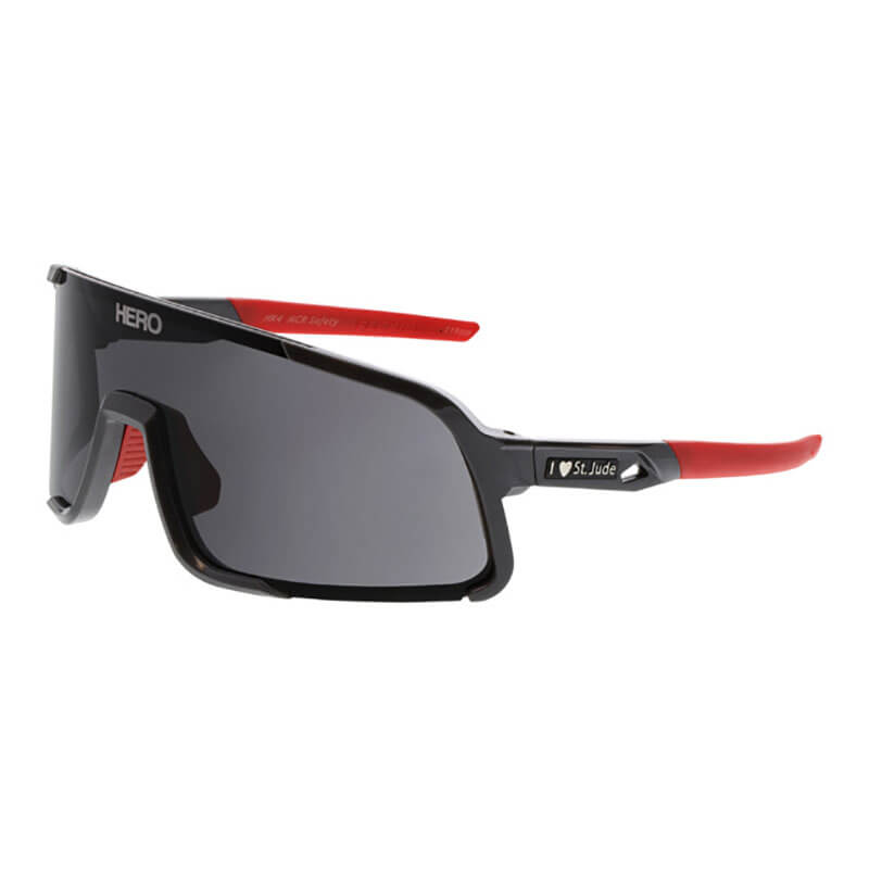 MCR Hulk HK4 St. Jude HERO Edition Safety Glasses by MCR Safety feature a rectangular black wraparound frame with dark lenses, red arms, “HERO” on the top left corner, and an “I ❤️ St. Jude” logo near the hinge. Sold 12 per box.