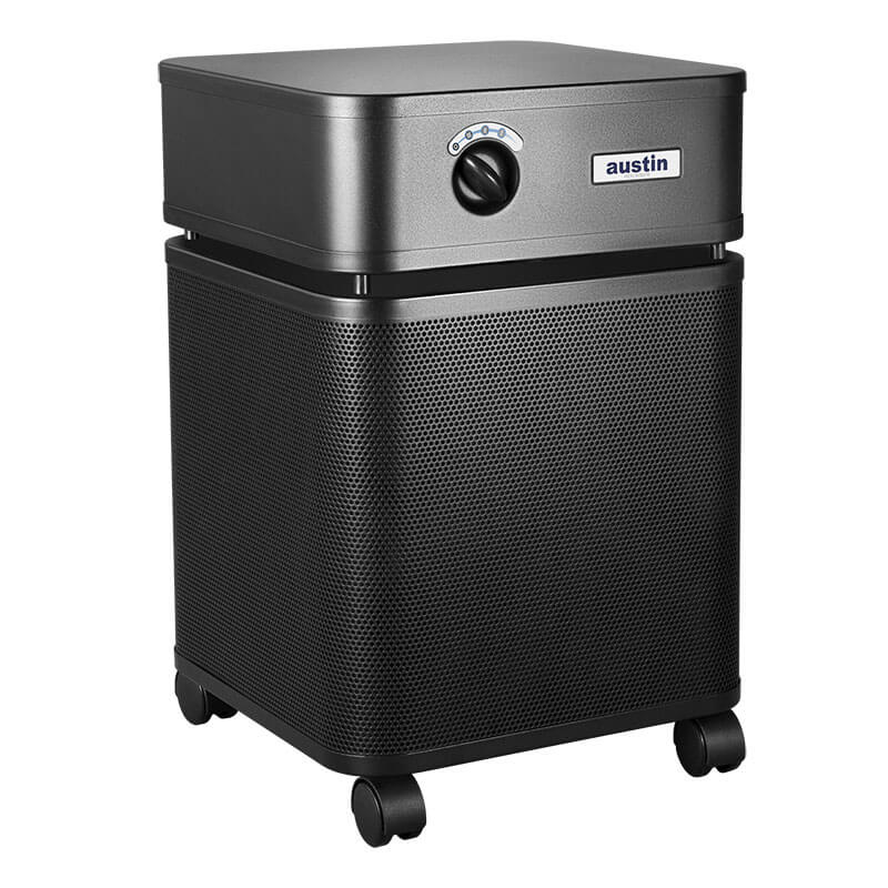 The Austin Air Systems HealthMate Plus Machine B450, in black with a square design, perforated front panel, control dial, and wheels, offers medical grade HEPA filtration for formaldehyde removal and is shown against a white background.