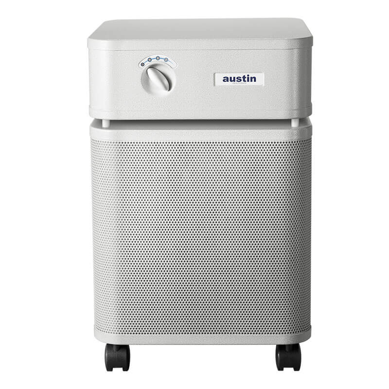 The Austin Air HealthMate Plus Machine B450 by Austin Air Systems is a white air purifier with a top control dial, perforated front, and four black wheels, featuring medical-grade HEPA filtration for effective formaldehyde removal.