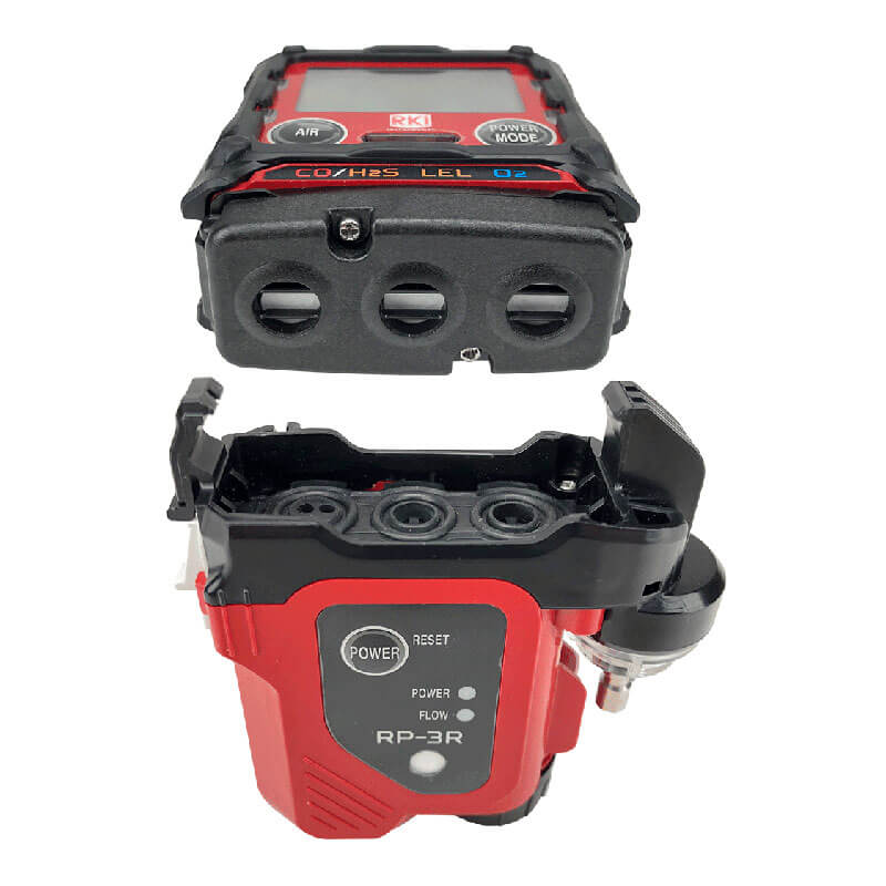 A close-up of the RKI Instruments RP-3R Sample Drawing Pump for GX-3R, a red and black multi-gas detector with an open bottom compartment showing labeled internal controls for confined space entry gas monitoring.