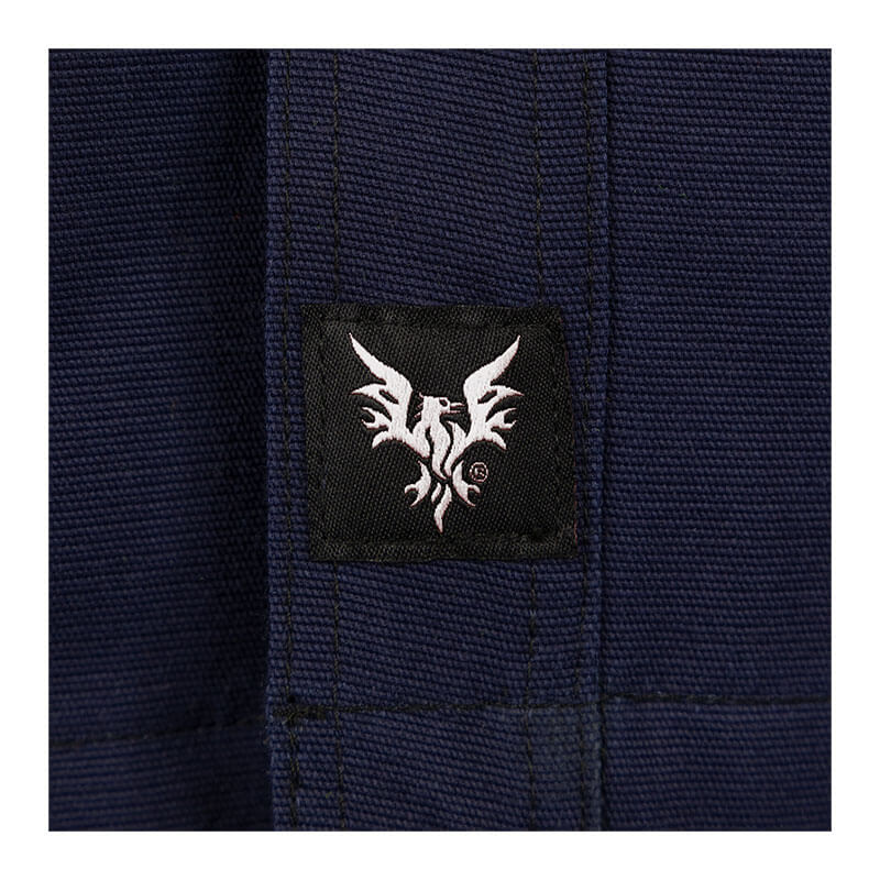 Close-up of the NSA DRIFIRE FR Range Flex Shirt Jacket JKT-6B in dark blue, showing visible stitching and a small black tag with a white stylized bird logo.