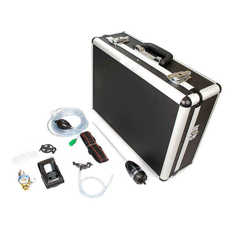 A black hard-shell case with metal edges sits open beside various tools and accessories like hoses, a gauge, a handle, connectors, and attachments. This tidy ensemble features the BW Honeywell GasAlert MicroClip Deluxe Confined Space Kit MC-CK-DL by BW Technologies, neatly arranged on a white background.