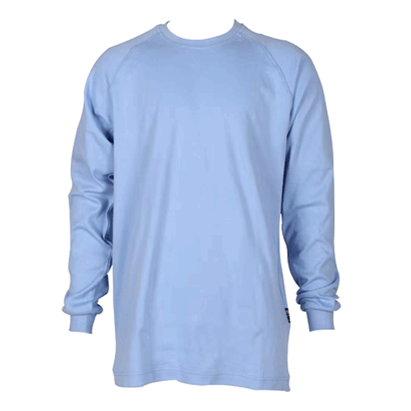The ForgeFR Crew Neck Tee, model MFRCNT-009, is depicted on a white backdrop as a plain light blue long-sleeve shirt with a subtle design. This 6.5 oz FR crew neck tee includes ribbed cuffs and combines safety and style seamlessly. It meets UL classified NFPA 2112 standards and maintains a clean look without visible logos or patterns.