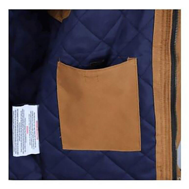 A close-up of the interior of the ForgeFR Canvas Duck Vest MFRVST-001 reveals a brown pocket and a white care label. Designed with NFPA2112 standards in mind, this vest ensures safety without compromising style.