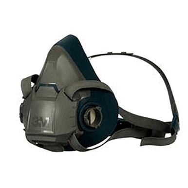 The image displays a 3M Half Facepiece Reusable Respirator 6500 Series in gray and black, featuring adjustable head straps and equipped with 3M cartridges, shown from a side angle.