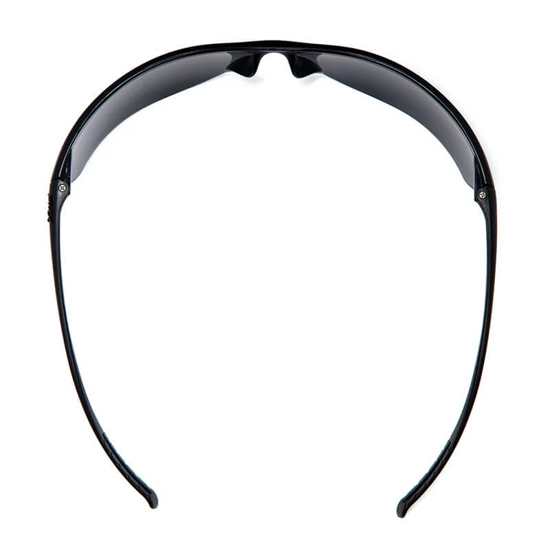 A pair of Pyramex Neshoba H2Max Anti-Fog Safety Glasses by Pyramex Safety is shown from above, highlighting the curved arms and dark polycarbonate lenses arranged in an arch-like shape.