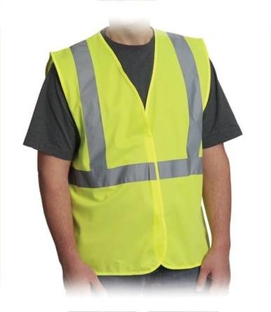 A person is wearing a PIP Class 2 Economy HI viz Yellow vest made from solid fabric, featuring reflective stripes and compliant with ANSI 107 Class 2 standards, over a dark shirt.