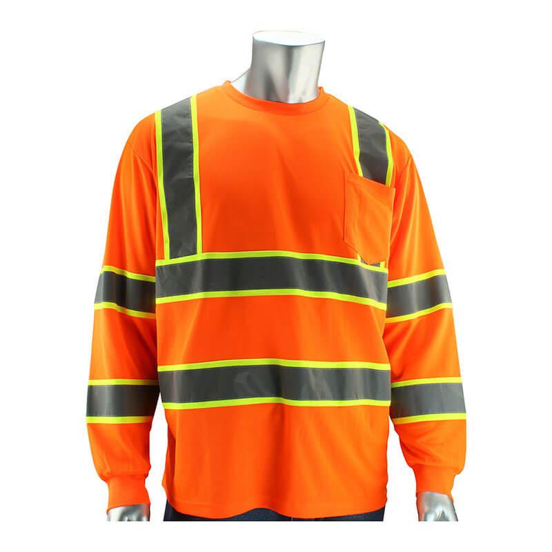 A mannequin displays the PIP Type R Class 3 Two-Tone Long Sleeve shirt, a bright orange hi-visibility long sleeve t-shirt by PIP - Protective Industrial Products. It features reflective yellow and gray stripes, a chest pocket, and is crafted from durable polyester birdseye mesh to ensure both safety and comfort for high-visibility apparel needs.