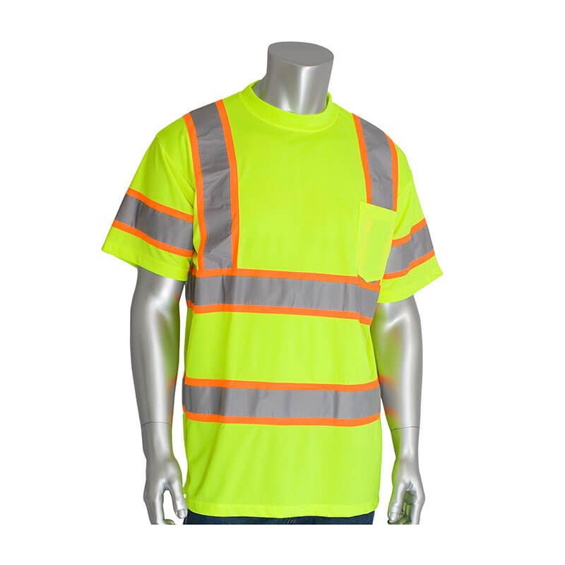 Displayed on a headless mannequin is the PIP ANSI Type R Class 3 Two-Tone T-Shirt by Protective Industrial Products. This hi-visibility apparel piece is ideal for construction and features a neon yellow color with gray reflective stripes and orange accents. It includes a chest pocket, short sleeves, and is made from performance wicking material to keep you cool while working.