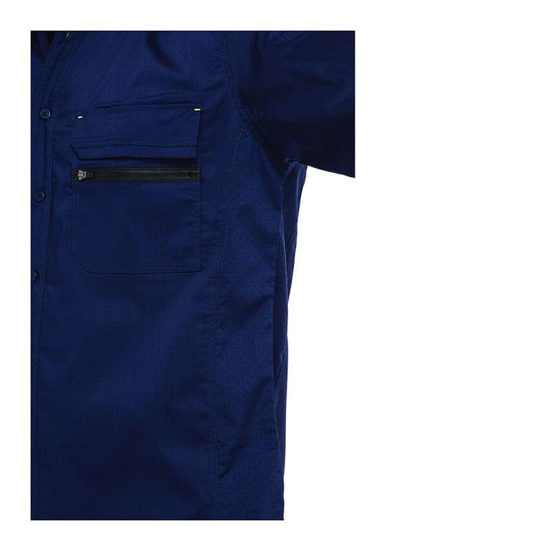 A close-up of a navy blue PIP Bisley Ripstop Work Shirt w/X-Airflow by Protective Industrial Products showcases its zippered chest pocket and button closures. The subtly textured fabric includes X-Airflow Ventilation, with the photo highlighting the shirt's upper left side against a plain white background.
