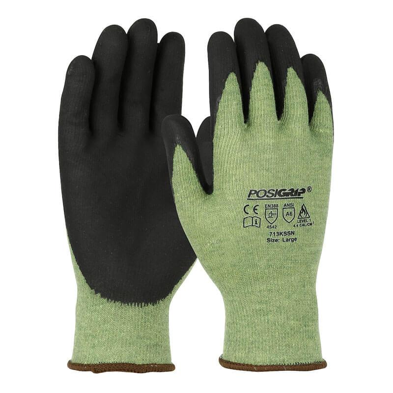 A pair of green PIP PosiGrip Seamless Gloves (713KSSN) with black nitrile foam-coated palms and fingers. Safety certification symbols and the PIP brand name appear on the back. Sold in packs of 12 pairs.
