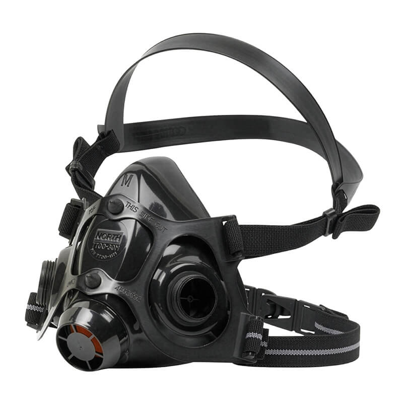 The PIP North 7700 Series Silicone Half Mask by PIP is a black industrial respirator made of medical-grade silicone with dual adjustable straps, multiple filter attachment points, a clear faceplate, and a circular front filter for protection against airborne contaminants.