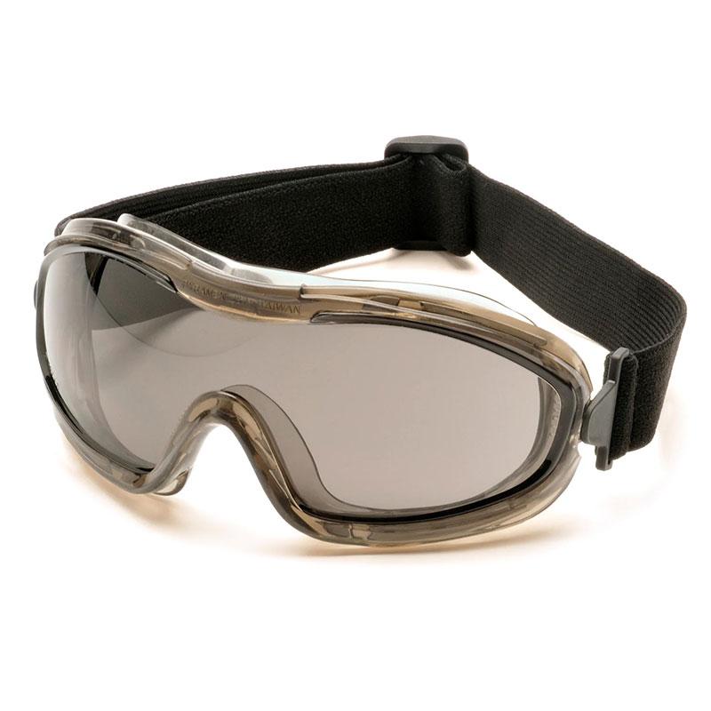 The Pyramex Low-Profile Chemical Splash Goggle from Pyramex Safety features tinted lenses and an adjustable black strap, providing eye protection with a modern sport design. Its sleek frame and dark lenses minimize glare, while compliance with ANSI Z87.1-2003 ensures dependable defense against chemical splashes.
