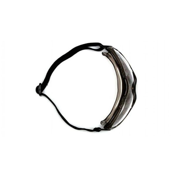 The Pyramex Low-Profile Chemical Splash Goggle by Pyramex Safety features a modern sport design with a black adjustable strap. It offers wide coverage with its clear visor to protect the eyes and face, ensuring a secure fit and ANSI Z87.1-2003 compliance for optimal safety.