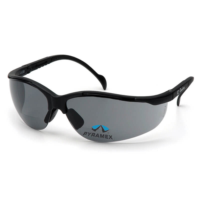 The Pyramex Venture II V2 Reader Safety Glasses feature a sleek design with black frames and tinted lenses. The "PYRAMEX" logo is displayed on one lens. These bifocal glasses, compliant with OSHA ANSI Z87.1 standards, provide maximum protection for users.