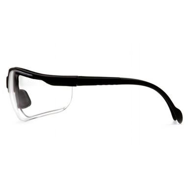 Side view of Pyramex Venture II Safety Glasses shows black frames with clear, curved lenses offering UV protection, featuring a sleek design with padded temples and nose for comfort. Brand: Pyramex Safety. Pack of 12/box.